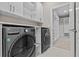 Well-organized laundry room with modern washer, dryer and a spacious closet at 10516 Tranquil Meadow Loop, Riverview, FL 33569
