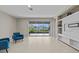Modern living room with tile flooring, a built-in entertainment center, and sliding glass doors to the outdoor space at 10516 Tranquil Meadow Loop, Riverview, FL 33569