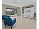 Stylish living room features tile floors, a modern entertainment center, and sliding glass doors to the outdoor living space at 10516 Tranquil Meadow Loop, Riverview, FL 33569