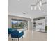 Inviting living room with neutral tile, access to outdoor patio, and built-in entertainment center at 10516 Tranquil Meadow Loop, Riverview, FL 33569