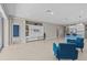 Spacious living area with tile floors, a contemporary entertainment center, and a seamless flow to the kitchen at 10516 Tranquil Meadow Loop, Riverview, FL 33569