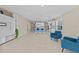 Open-concept living area with tile floors, stylish furnishings, and a view into the modern kitchen and dining area at 10516 Tranquil Meadow Loop, Riverview, FL 33569