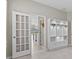 Living area with built-in shelving and cabinetry, with doorway views of an open floor plan at 10516 Tranquil Meadow Loop, Riverview, FL 33569
