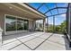 Covered patio with screen, seating, and sliding glass doors leading into the home at 10516 Tranquil Meadow Loop, Riverview, FL 33569