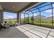The covered patio features ample room for seating and beautiful views of the landscaped backyard at 10516 Tranquil Meadow Loop, Riverview, FL 33569