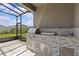 This patio kitchen features a stainless steel grill, sink, and ample counter space at 10516 Tranquil Meadow Loop, Riverview, FL 33569