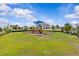 Community playground featuring colorful play structures and ample green space for recreational activities at 10516 Tranquil Meadow Loop, Riverview, FL 33569