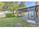 The home features an outdoor space with a screened-in lanai and a manicured lawn at 4305 Balmoral Ct, Wesley Chapel, FL 33543