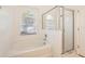 Bright bathroom featuring a garden tub with shower head and a separate glass enclosed shower at 4305 Balmoral Ct, Wesley Chapel, FL 33543
