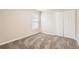 Bedroom with plush carpeting, a window providing natural light, and a closet with folding doors at 4305 Balmoral Ct, Wesley Chapel, FL 33543