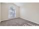 Carpeted bedroom with a large window allowing natural light at 4305 Balmoral Ct, Wesley Chapel, FL 33543