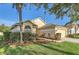 Well-maintained home featuring an attached garage, lush landscaping, and a charming front yard at 4305 Balmoral Ct, Wesley Chapel, FL 33543