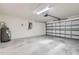 Spacious garage with an automatic door, room for storage, and an installed water heater at 4305 Balmoral Ct, Wesley Chapel, FL 33543