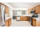 Well-lit kitchen features stainless steel appliances, tile flooring, and plentiful cabinet space at 4305 Balmoral Ct, Wesley Chapel, FL 33543