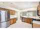 Bright kitchen featuring stainless steel appliances, oak cabinetry, and tile flooring at 4305 Balmoral Ct, Wesley Chapel, FL 33543