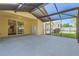 Spacious screened lanai with views of a well-maintained backyard and house exterior at 4305 Balmoral Ct, Wesley Chapel, FL 33543