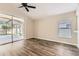 Comfortable living room with wood floors and sliding glass doors to the screened lanai at 4305 Balmoral Ct, Wesley Chapel, FL 33543