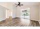 Spacious living room with wood floors and sliding glass doors to the screened lanai at 4305 Balmoral Ct, Wesley Chapel, FL 33543