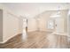 Bright, open-concept living area featuring vaulted ceilings and wood-look flooring at 4305 Balmoral Ct, Wesley Chapel, FL 33543