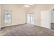 Large main bedroom with neutral carpet and sliding glass doors to the screened lanai at 4305 Balmoral Ct, Wesley Chapel, FL 33543