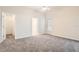 Neutral main bedroom featuring carpet, a ceiling fan, and entry to the main bathroom at 4305 Balmoral Ct, Wesley Chapel, FL 33543