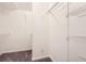 Large walk-in closet with shelving and carpet flooring at 4305 Balmoral Ct, Wesley Chapel, FL 33543