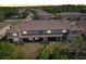 Neighborhood aerial view showing multiple homes, well-maintained lawns, and community pool at 11632 Castine St, New Port Richey, FL 34654