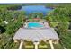 Aerial shot displays the community pool, clubhouse, and lake access for community residents at 11632 Castine St, New Port Richey, FL 34654