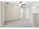 Bedroom featuring plush carpeting, a ceiling fan, and white trim with closet access at 11632 Castine St, New Port Richey, FL 34654