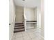 Entryway with staircase, built-in desk and tile floors at 11632 Castine St, New Port Richey, FL 34654