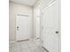 Neutral foyer featuring tile flooring and two white doors at 11632 Castine St, New Port Richey, FL 34654