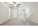 Bright hallway with neutral carpet, white walls, and a ceiling fan at 11632 Castine St, New Port Richey, FL 34654