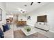 Living room is virtually staged with modern furniture, decor, and a view of the kitchen at 11632 Castine St, New Port Richey, FL 34654