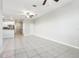Spacious living room with ceiling fan, tile floors and access to the kitchen and other rooms at 11632 Castine St, New Port Richey, FL 34654