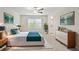 Virtually staged main bedroom featuring a cozy bed, wall art, a side table, and ample natural light at 11632 Castine St, New Port Richey, FL 34654