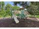 Community playground with slides, climbing structures, and shaded areas for children to enjoy at 11632 Castine St, New Port Richey, FL 34654