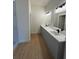 Modern bathroom featuring double sinks with sleek countertops and contemporary fixtures at 353 Warrington Blvd, Port Charlotte, FL 33954