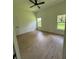 Bright bedroom featuring wood-look flooring, two large windows for natural light, and neutral-colored walls at 353 Warrington Blvd, Port Charlotte, FL 33954