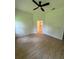 A bright bedroom with a ceiling fan, neutral walls, and wood-look floors at 353 Warrington Blvd, Port Charlotte, FL 33954
