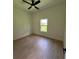 Inviting bedroom features hardwood floors and a window that offers ample natural light at 353 Warrington Blvd, Port Charlotte, FL 33954
