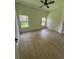 Bright bedroom with hardwood floors, two windows providing ample natural light at 353 Warrington Blvd, Port Charlotte, FL 33954