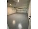 Spacious garage with speckled floor, overhead door, and plenty of room for parking at 353 Warrington Blvd, Port Charlotte, FL 33954