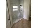 New bathroom showcases a stylish walk-in shower with marble-like tiling and a window at 353 Warrington Blvd, Port Charlotte, FL 33954