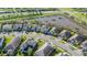 Aerial view of a neighborhood showcasing lush landscaping, serene pond, and well-maintained homes at 4861 Antrim Dr, Sarasota, FL 34240