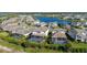 Aerial view of neighborhood homes with screened pools backing up to a large pond at 4861 Antrim Dr, Sarasota, FL 34240