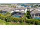 Aerial view of a fenced backyard with a screened pool and spa in a residential neighborhood at 4861 Antrim Dr, Sarasota, FL 34240