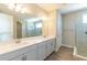 Bathroom showcasing a double sink vanity, a glass-enclosed shower, and tile flooring at 4861 Antrim Dr, Sarasota, FL 34240
