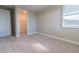 This carpeted bedroom offers neutral walls, a window for natural light, and a convenient walk-in closet at 4861 Antrim Dr, Sarasota, FL 34240