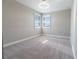 This well-lit bedroom boasts neutral walls, carpet flooring, and stylish lighting fixtures at 4861 Antrim Dr, Sarasota, FL 34240