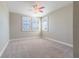 This carpeted bedroom features white trim, three windows, and neutral walls, creating a bright and airy space at 4861 Antrim Dr, Sarasota, FL 34240